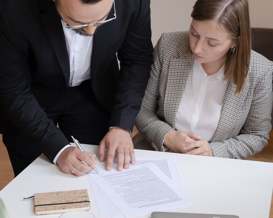 Deux personnes signent un contrat au bureau