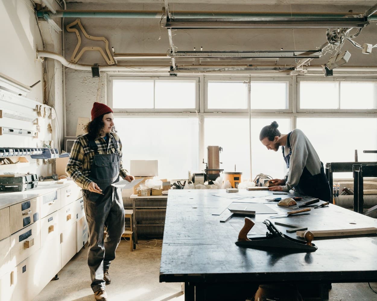 Deux artisans travaillent à l’établi dans leur atelier